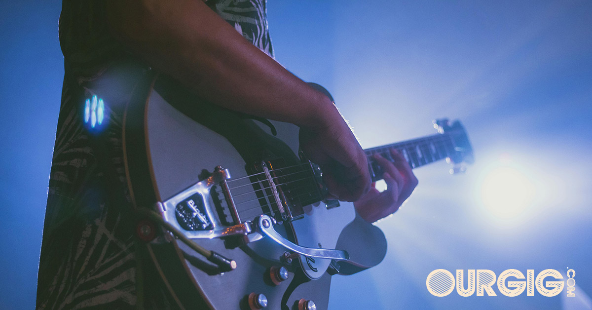 man playing guitar on stage
