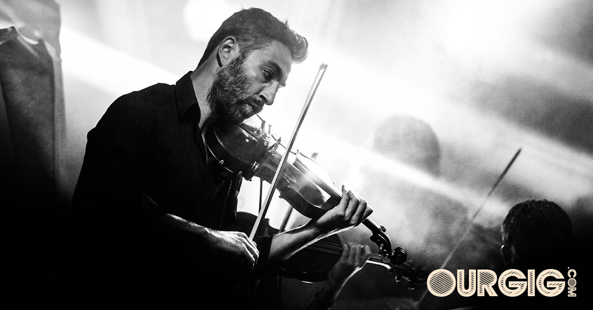 man playing violin in concert with very cool lights