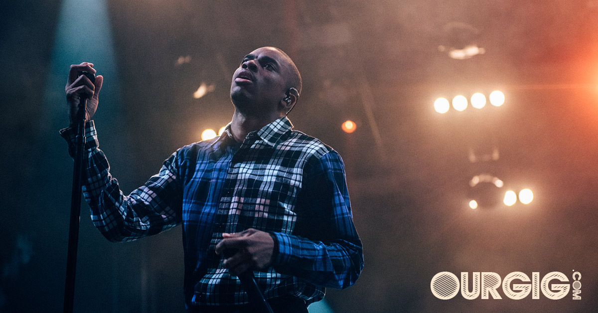 main in plaid shirt on stage