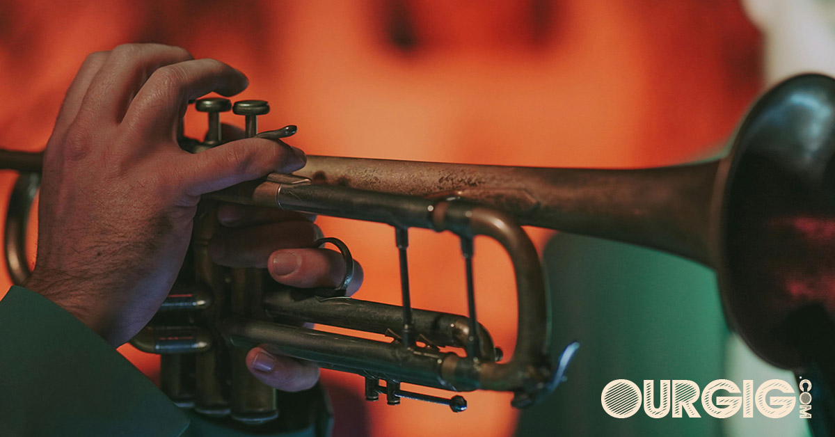 man playing trumpet at a show