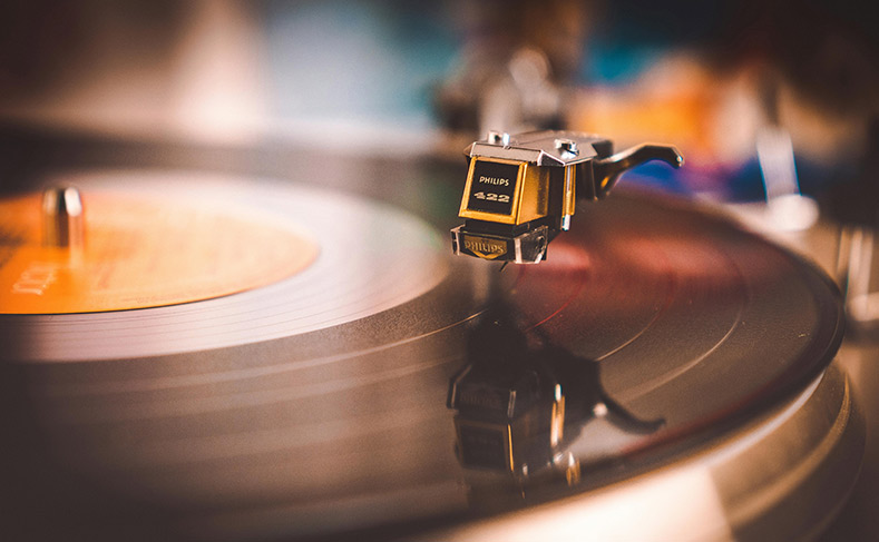A vinyl LP playing on the turntable