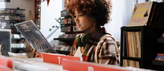 young woman looking for vinyl records