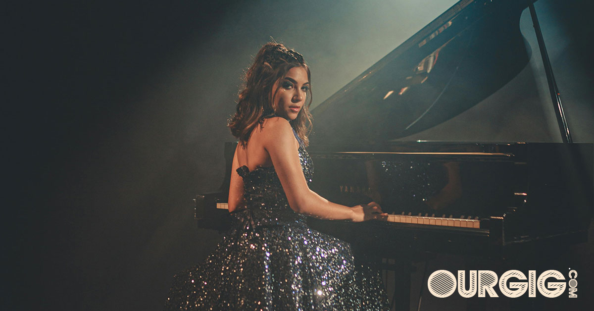 woman playing piano in concert ourgig.com