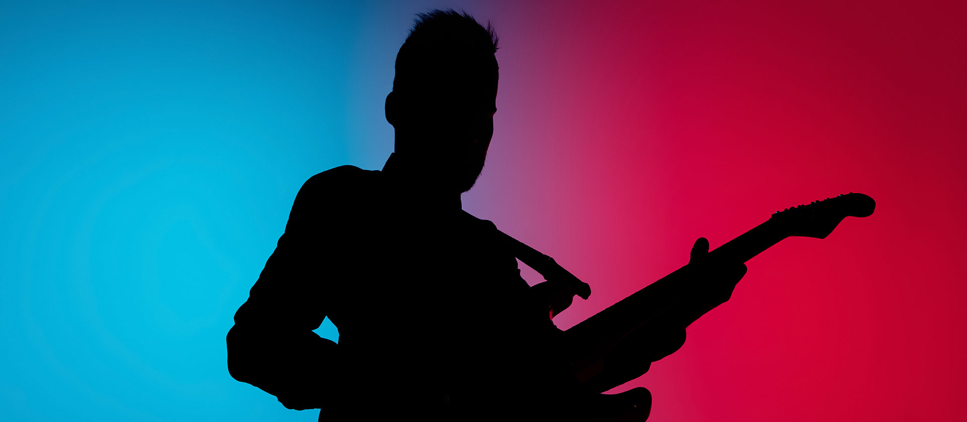 silhouette of guitar player on stage