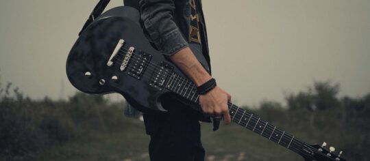 Guitar Player in an open field
