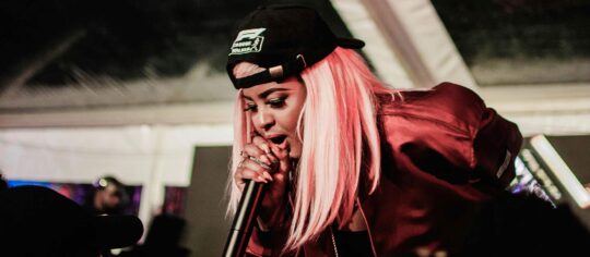 female hip-hop artist performing on state