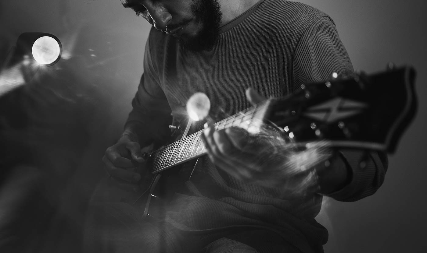 man playing guitar on stage
