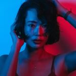 woman under colorful lights