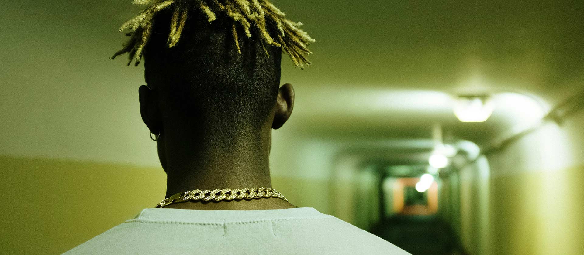 recording artist walking into a train station