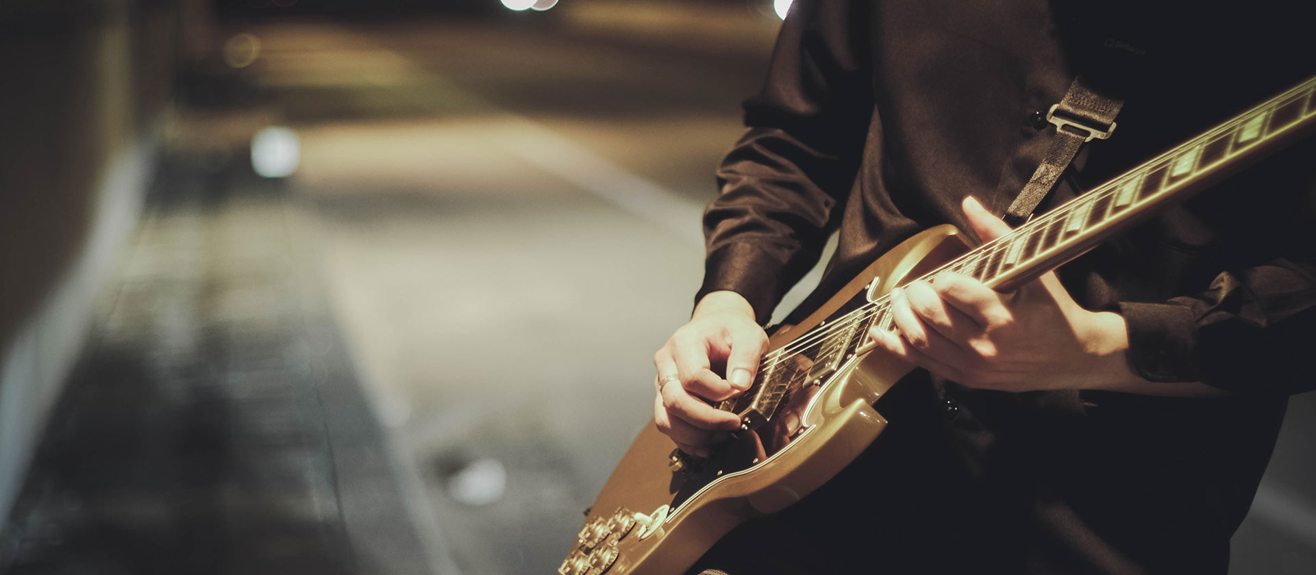 man playing guitar in the tunnel