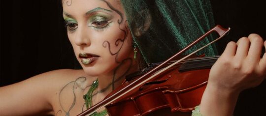 woman playing violin, very cool makeup