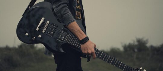 guitar player in field