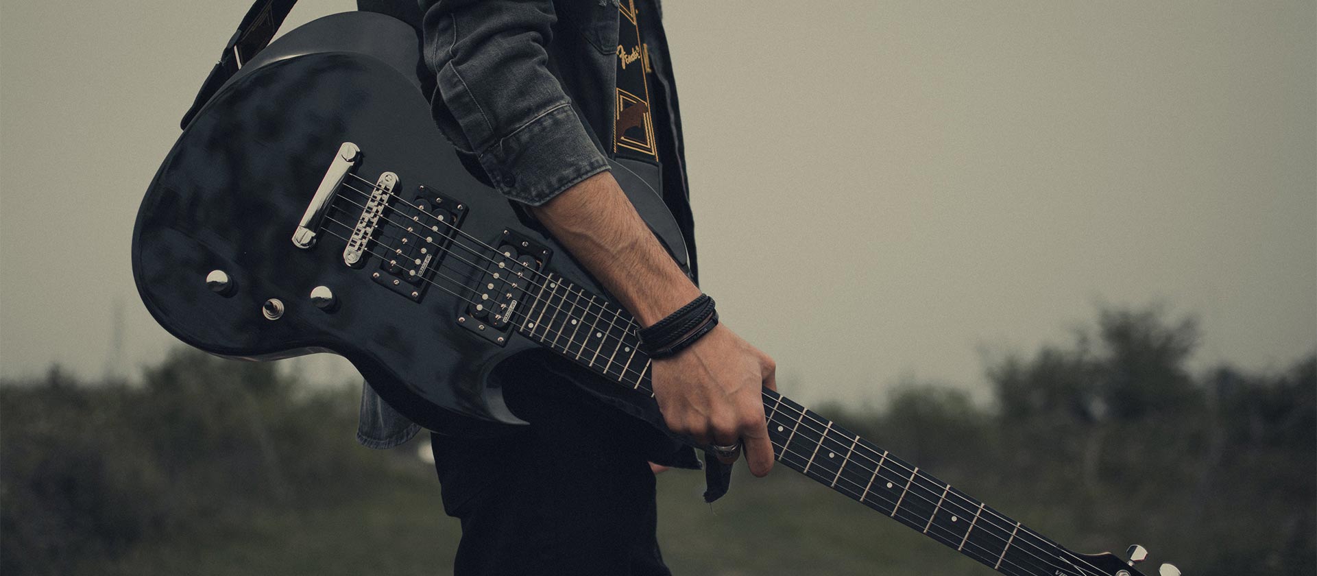 guitar player in field