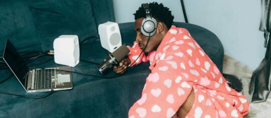 man podcasting in his pajamas