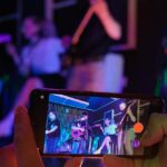 someone taking video of band rehearsal on cell phone