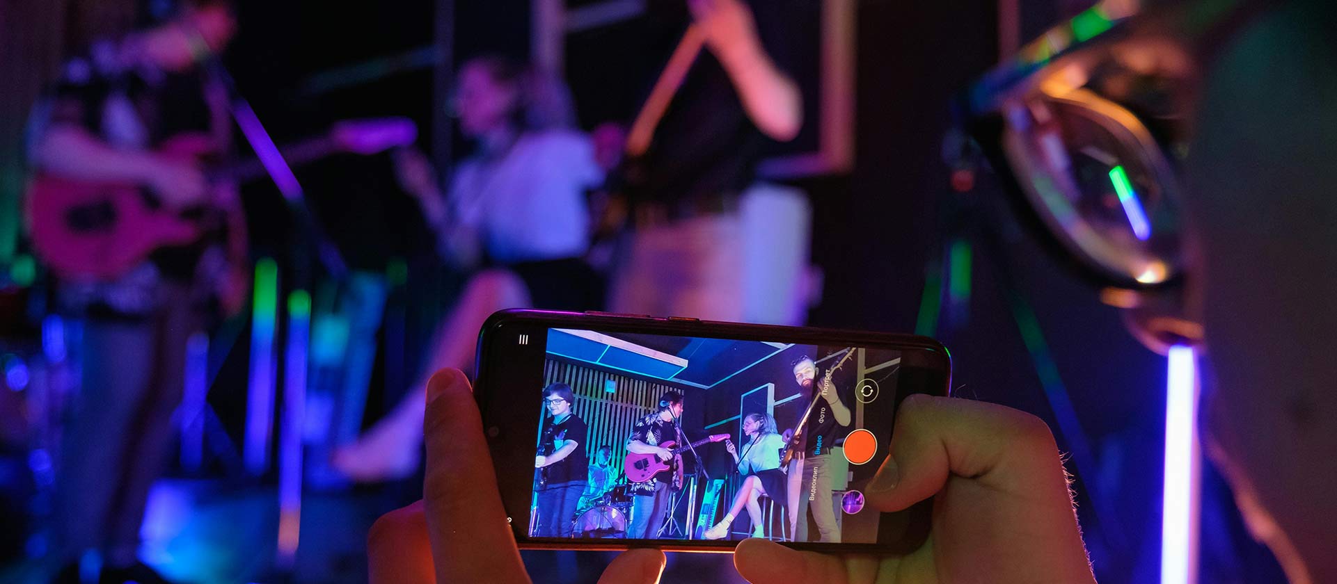 someone taking video of band rehearsal on cell phone