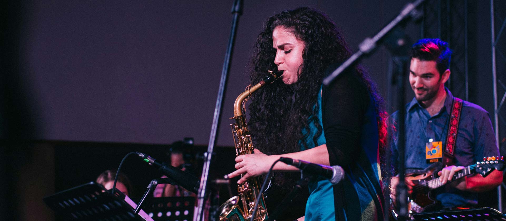 female saxophonist performing with band
