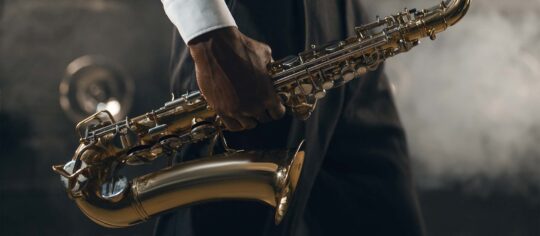 man holding saxophone