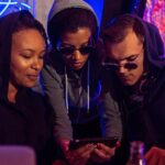 friends looking at social media on a phone