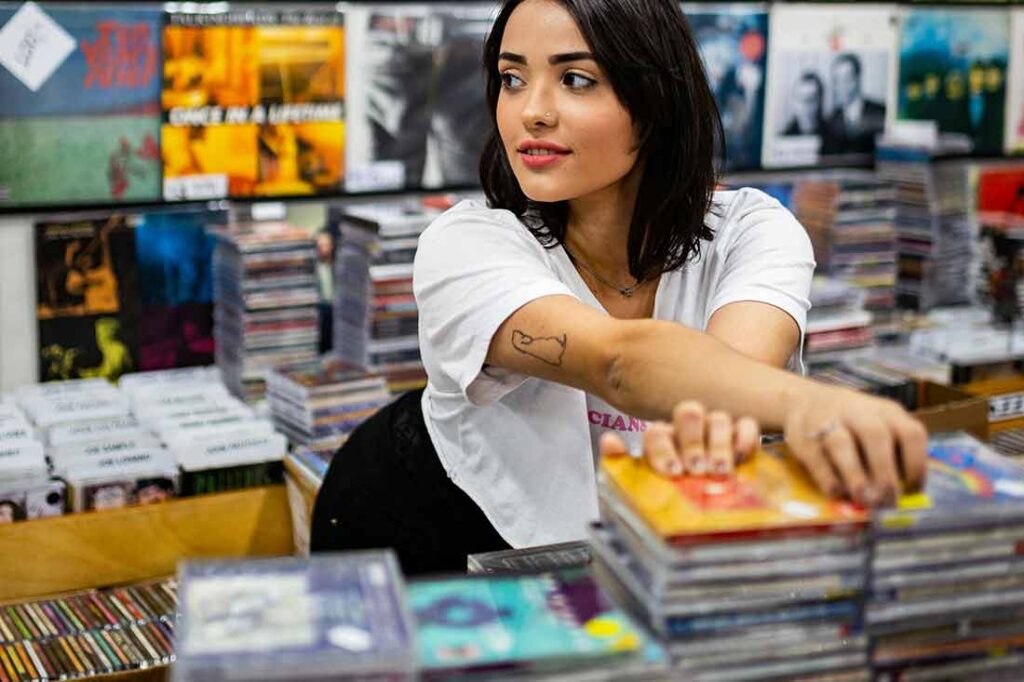 young woman looking through CD's
