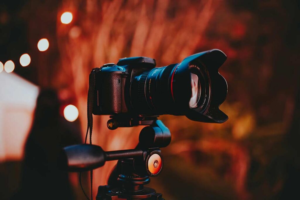camera on tripod at outdoor music festival