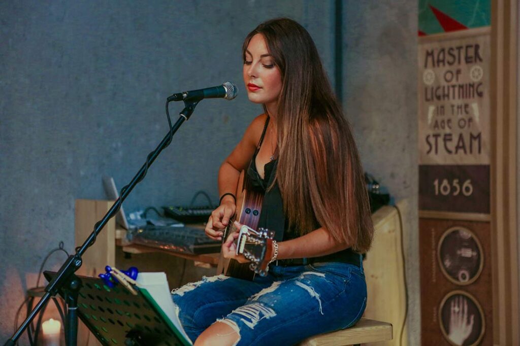 female artist performing in coffee house