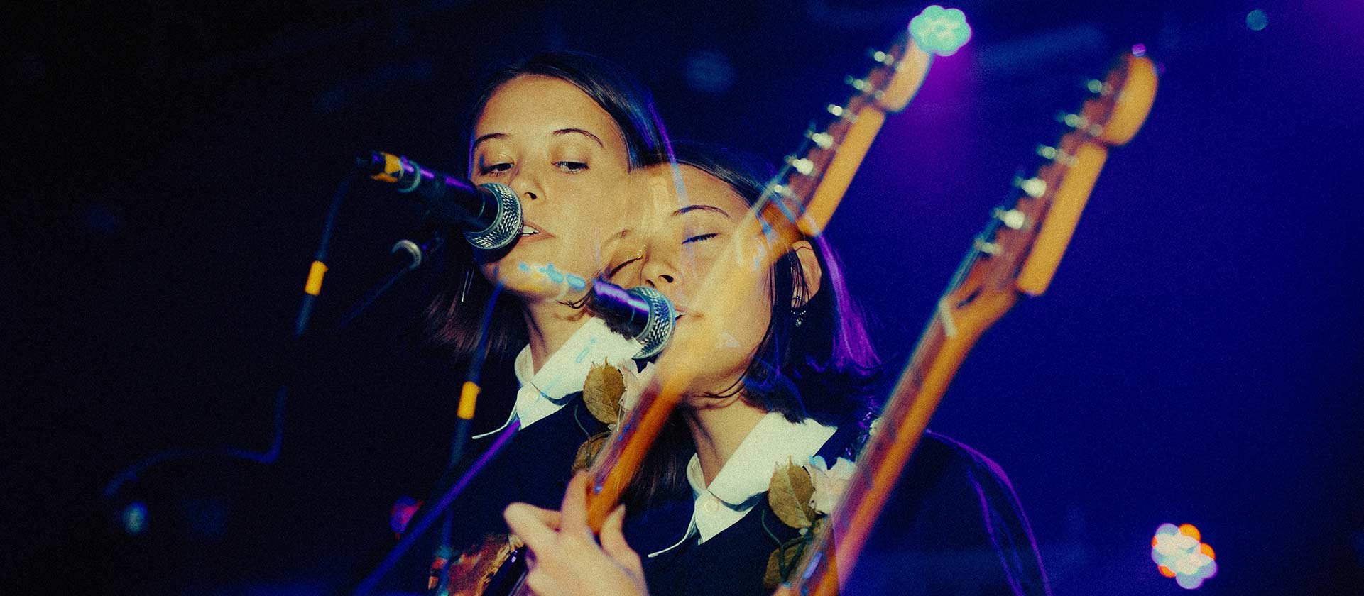 female artist playing guitar nd singing
