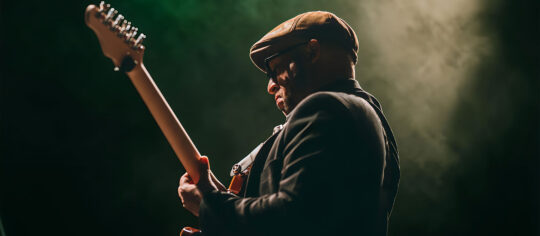 male guitar player on stage