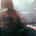 female musician practicing guitar