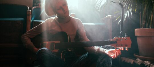 female musician practicing guitar