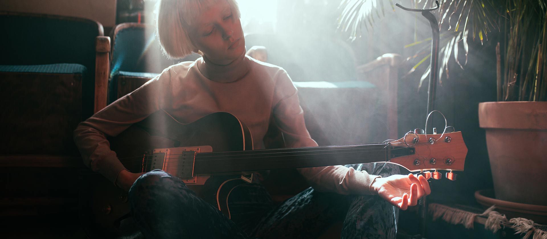 female musician practicing guitar