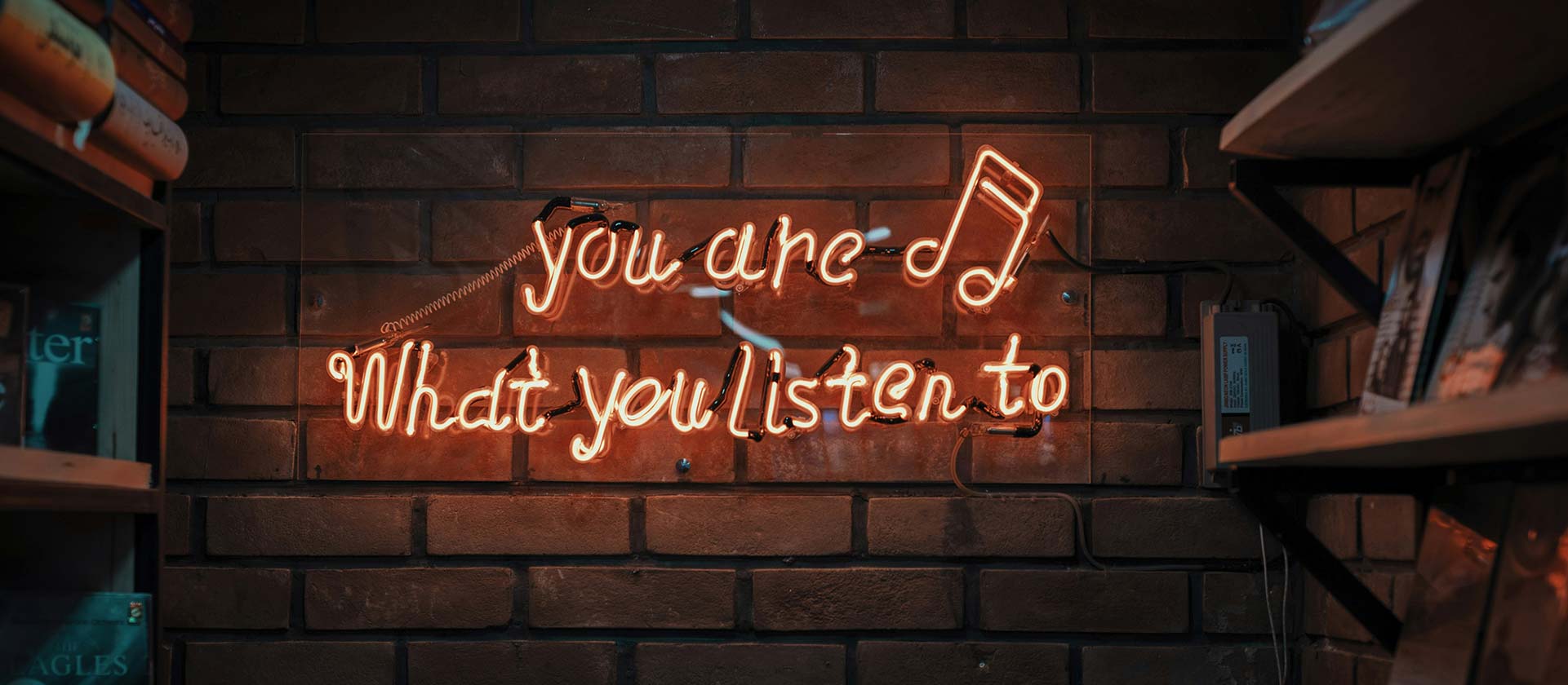 a neon sign saying you are what you listen to