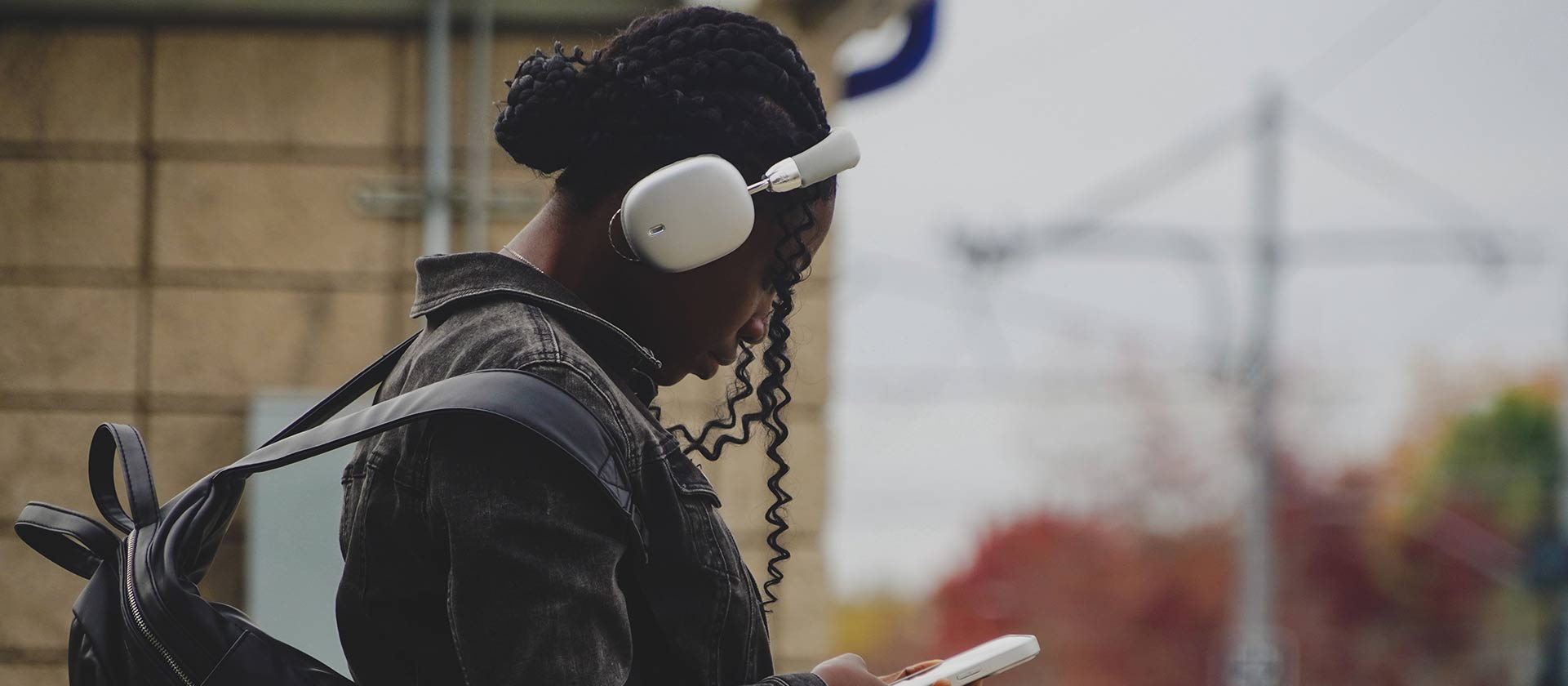 girl wearing earphones while waiting for train