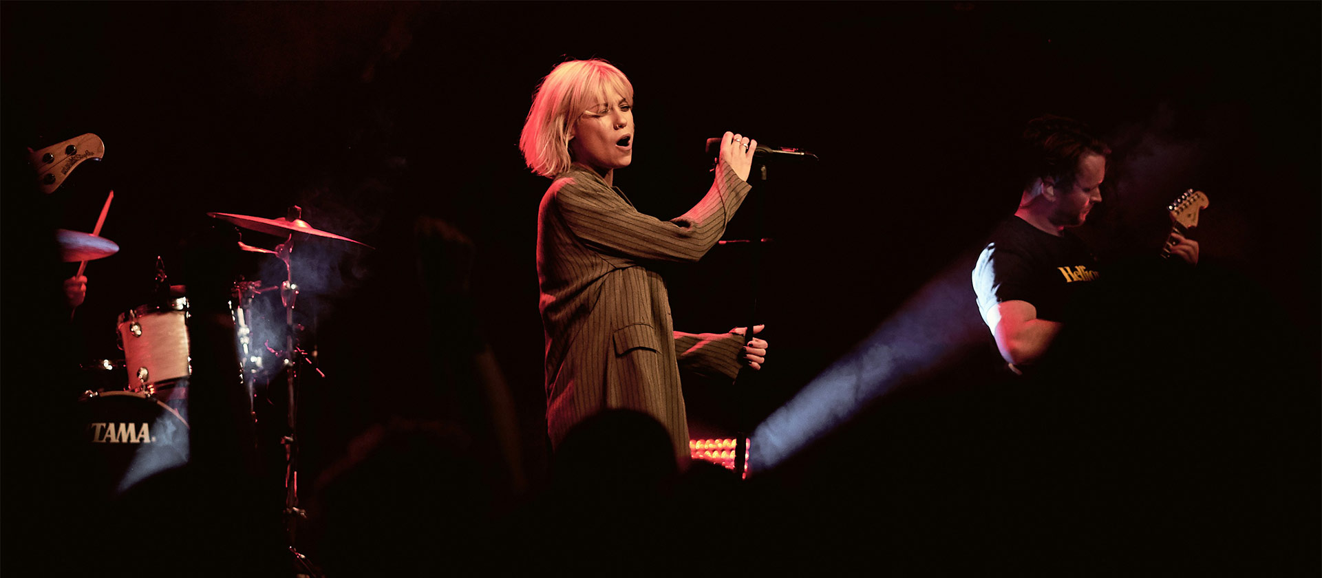 female vocalist with band on stage
