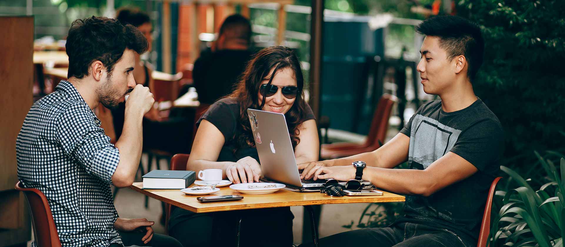 marketing team working on strategy in coffee shop