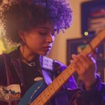 female artist playing bass
